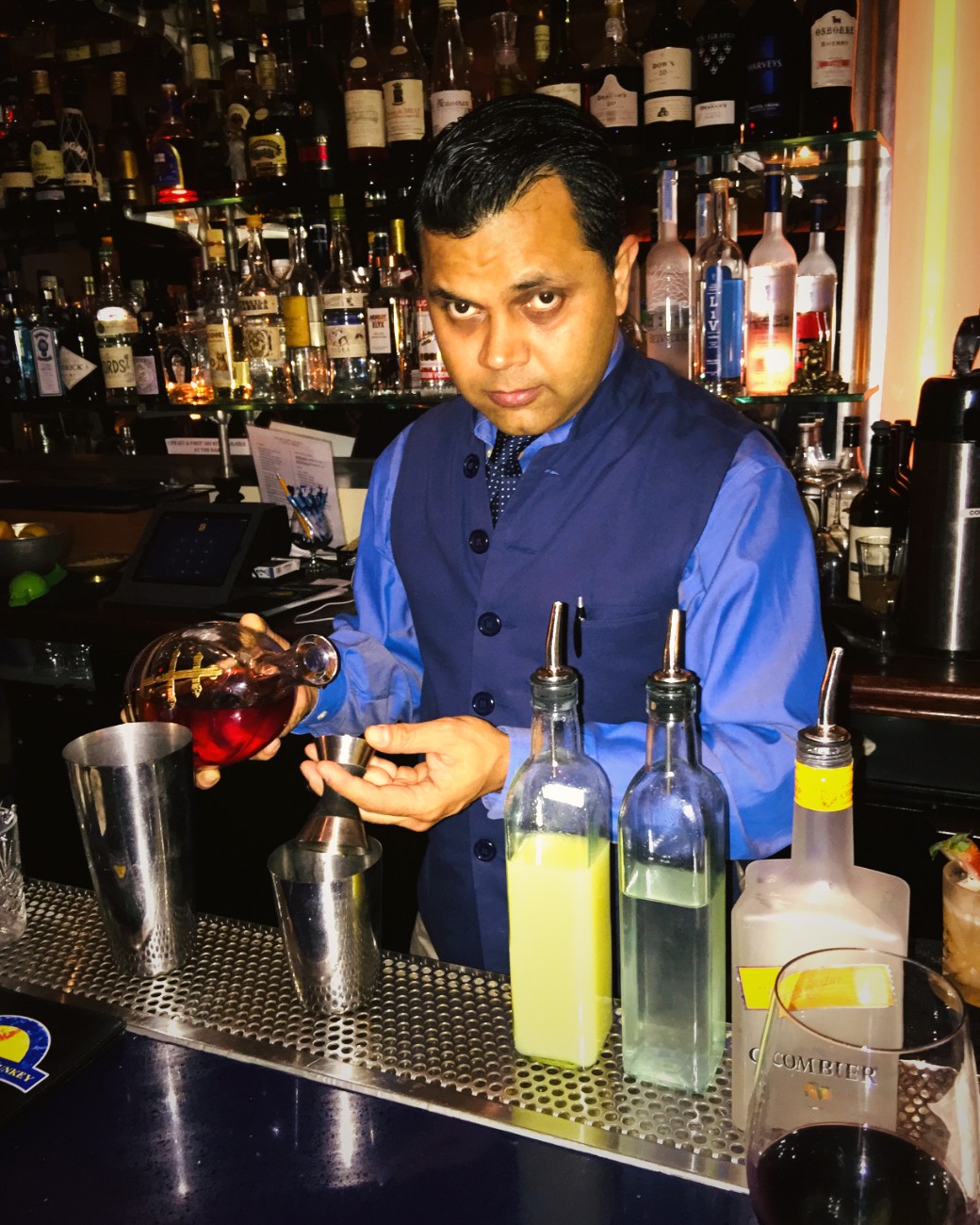 Founder Arun Mirchandani mixing a drink behind the bar at The Drunken Munkey