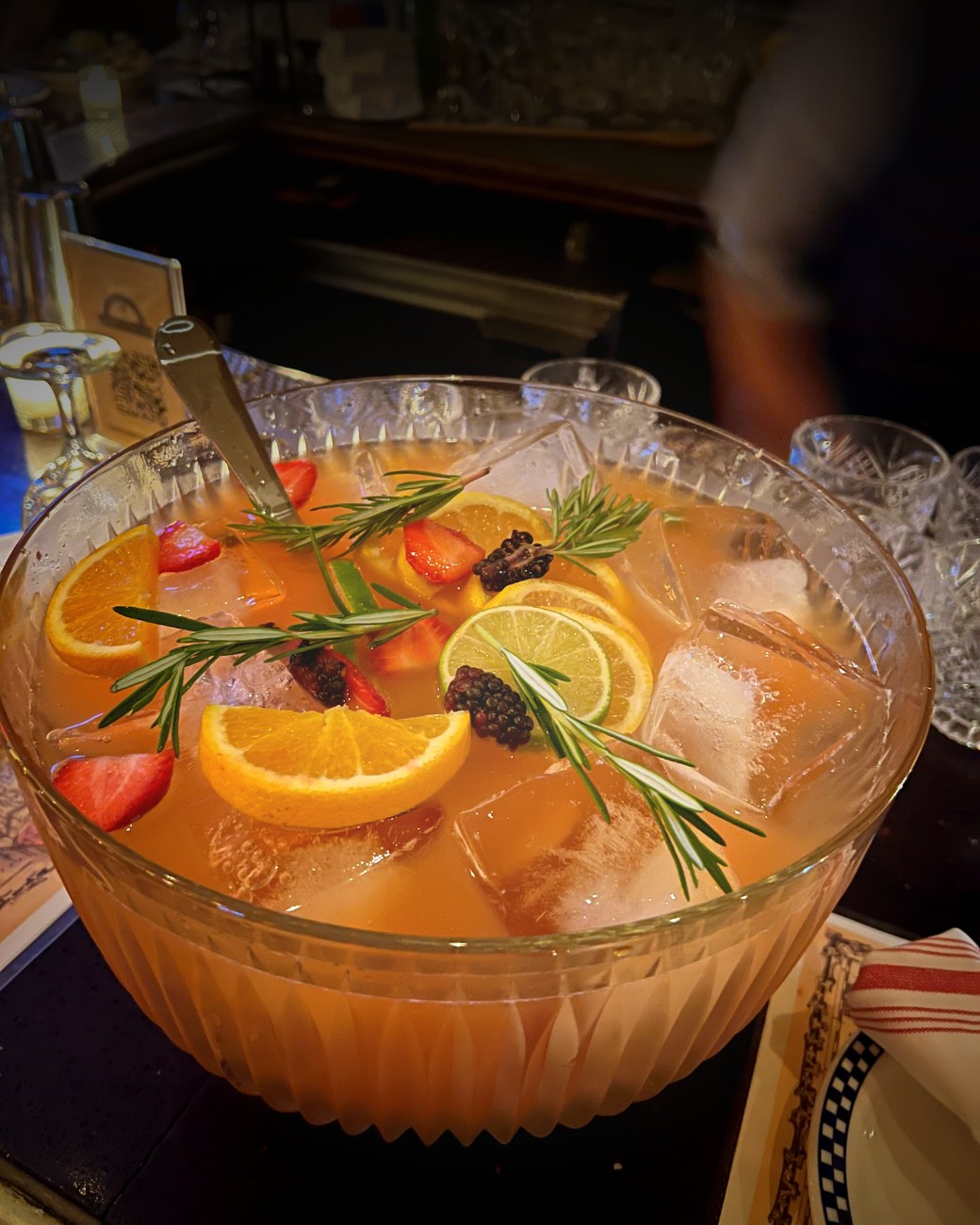The Munkey House Paanch — a communal punch bowl at The Drunken Munkey, garnished with citrus, berries and rosemary